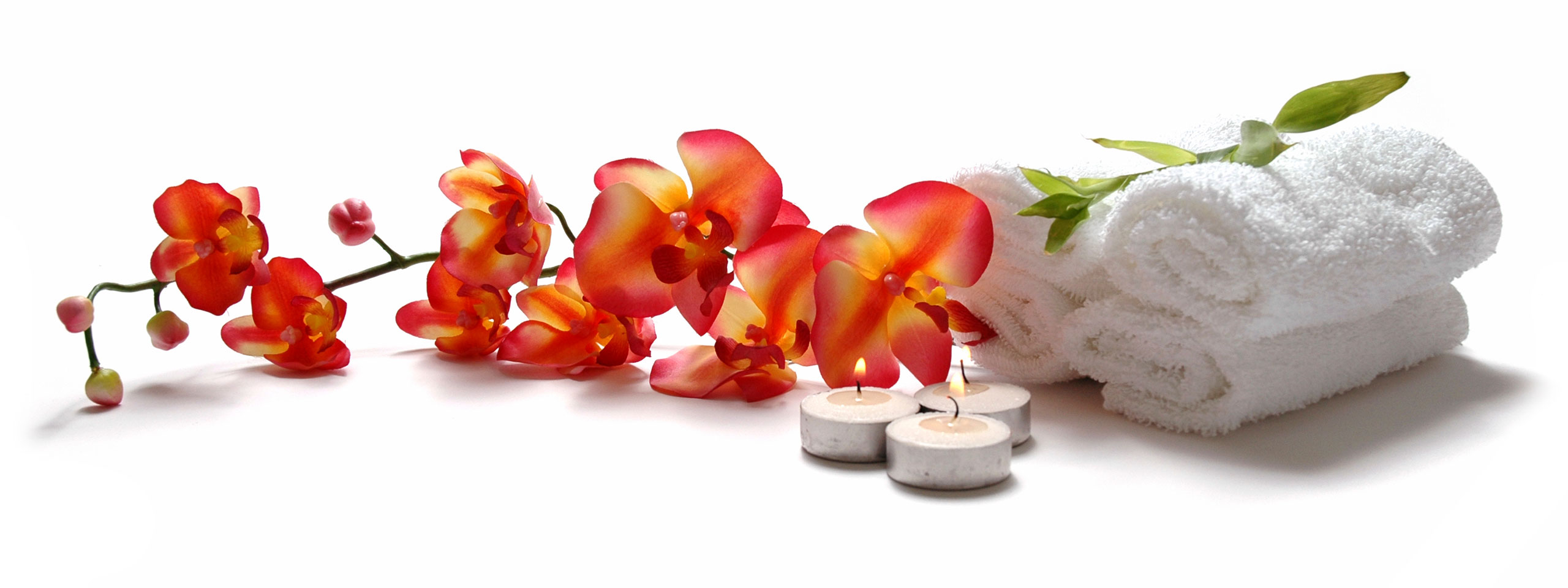 Red orchids, tea light candles and white towels